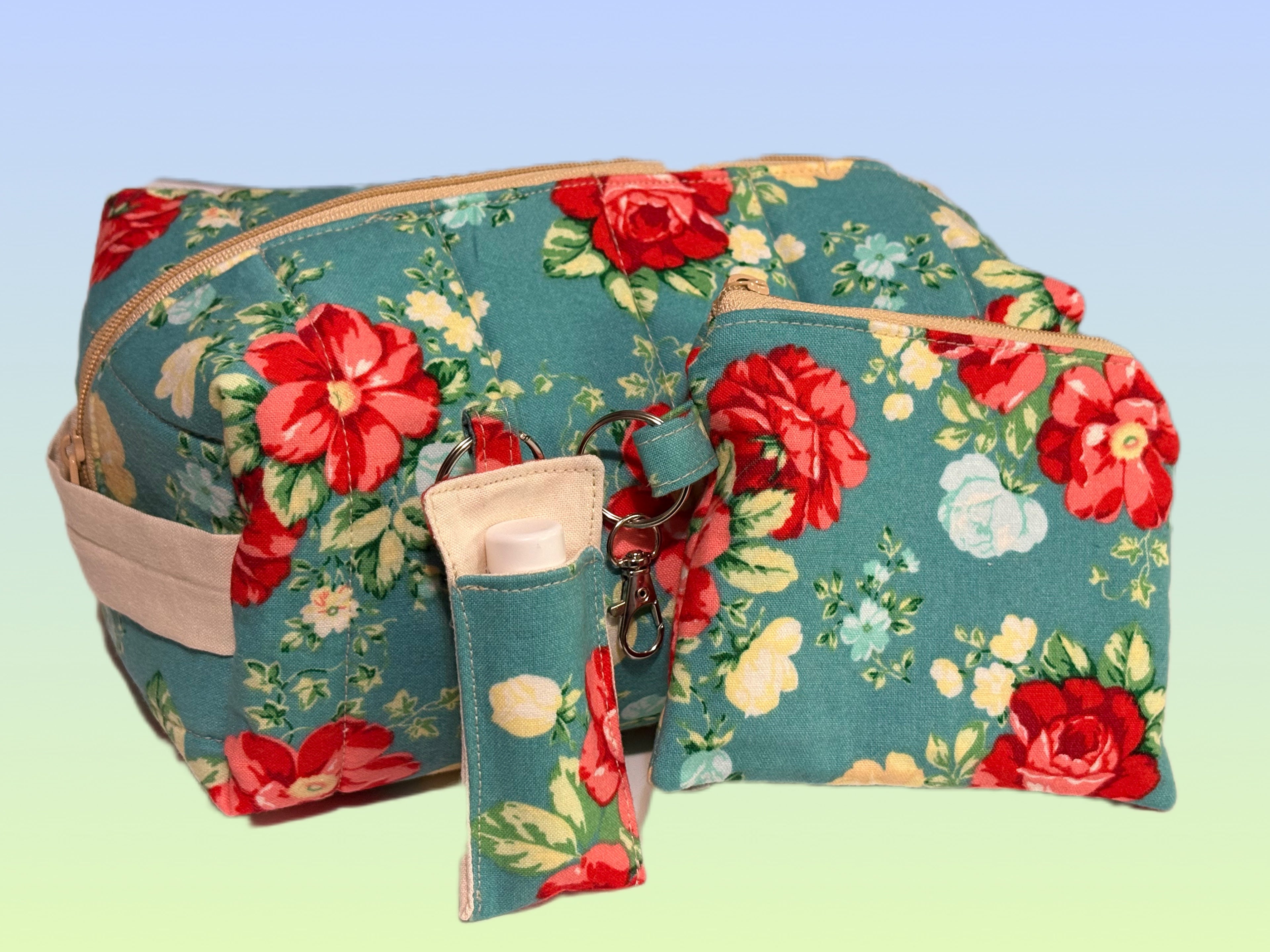 Handmade teal floral accessory set featuring a quilted boxy bag, coin purse, and chapstick holder keychain.