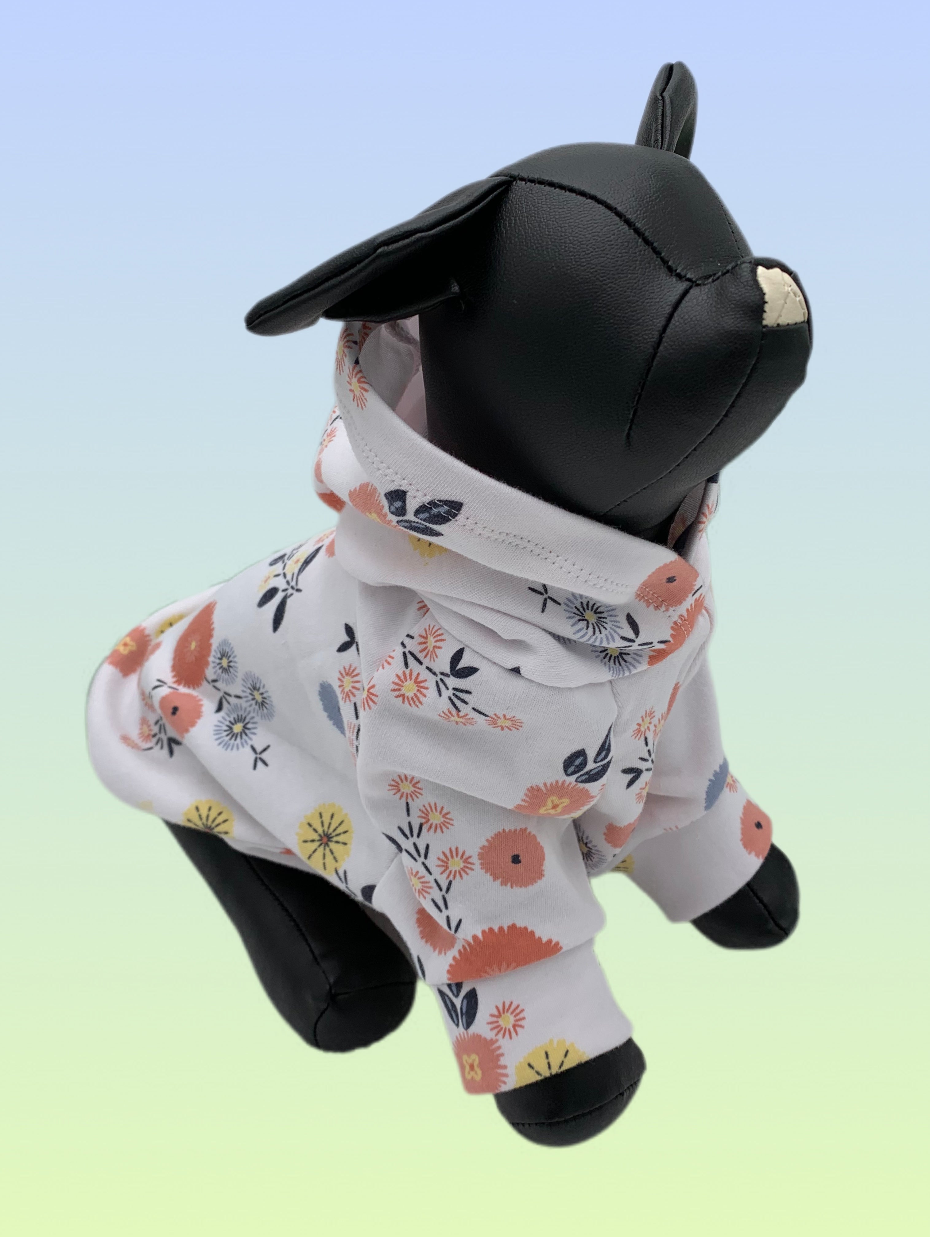 Handmade white floral dog hoodie with soft stretch fabric displayed on a small dog mannequin.
