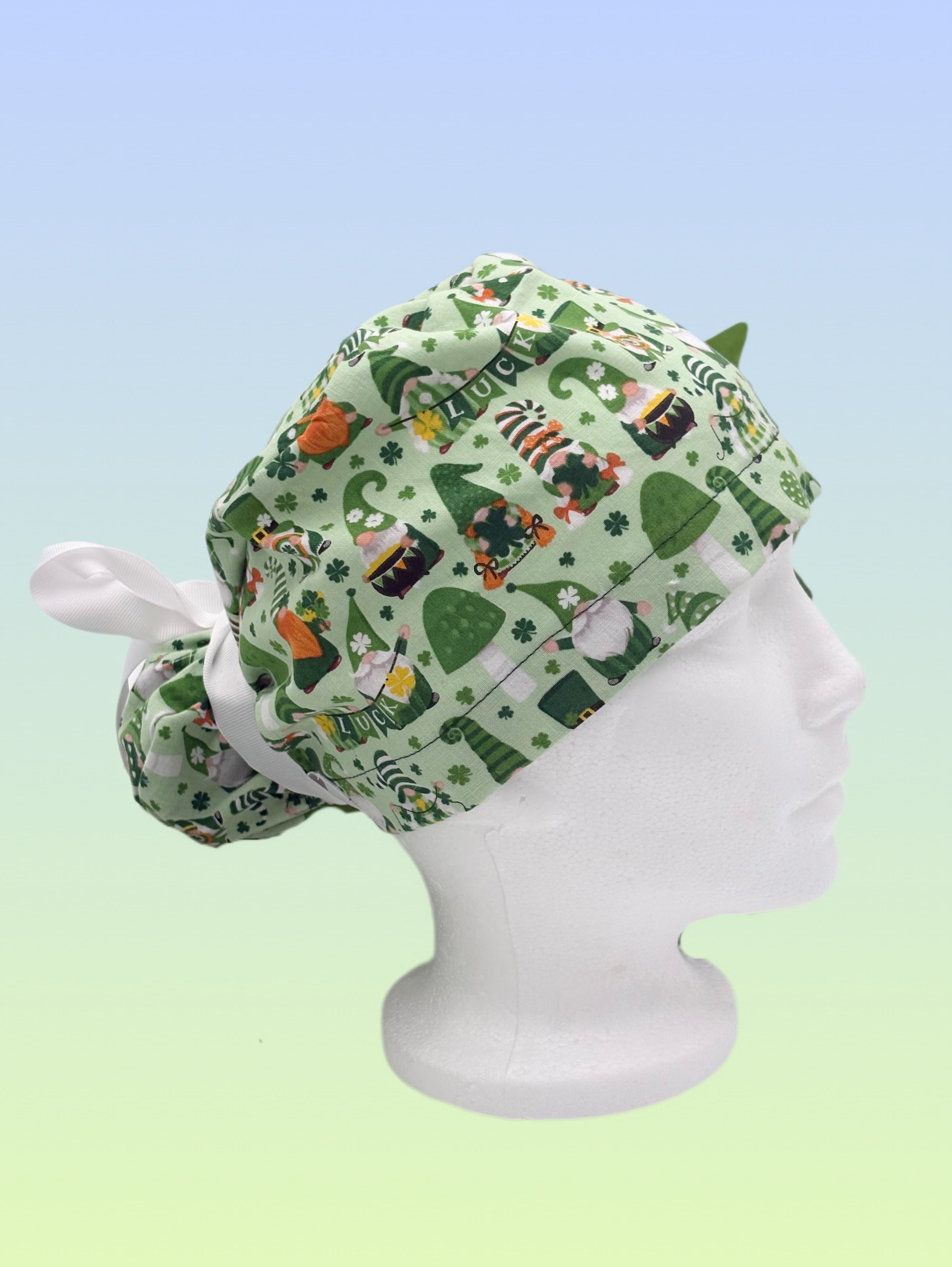 Handmade St. Patrick’s Day scrub cap with green gnome and shamrock print and adjustable tie back.