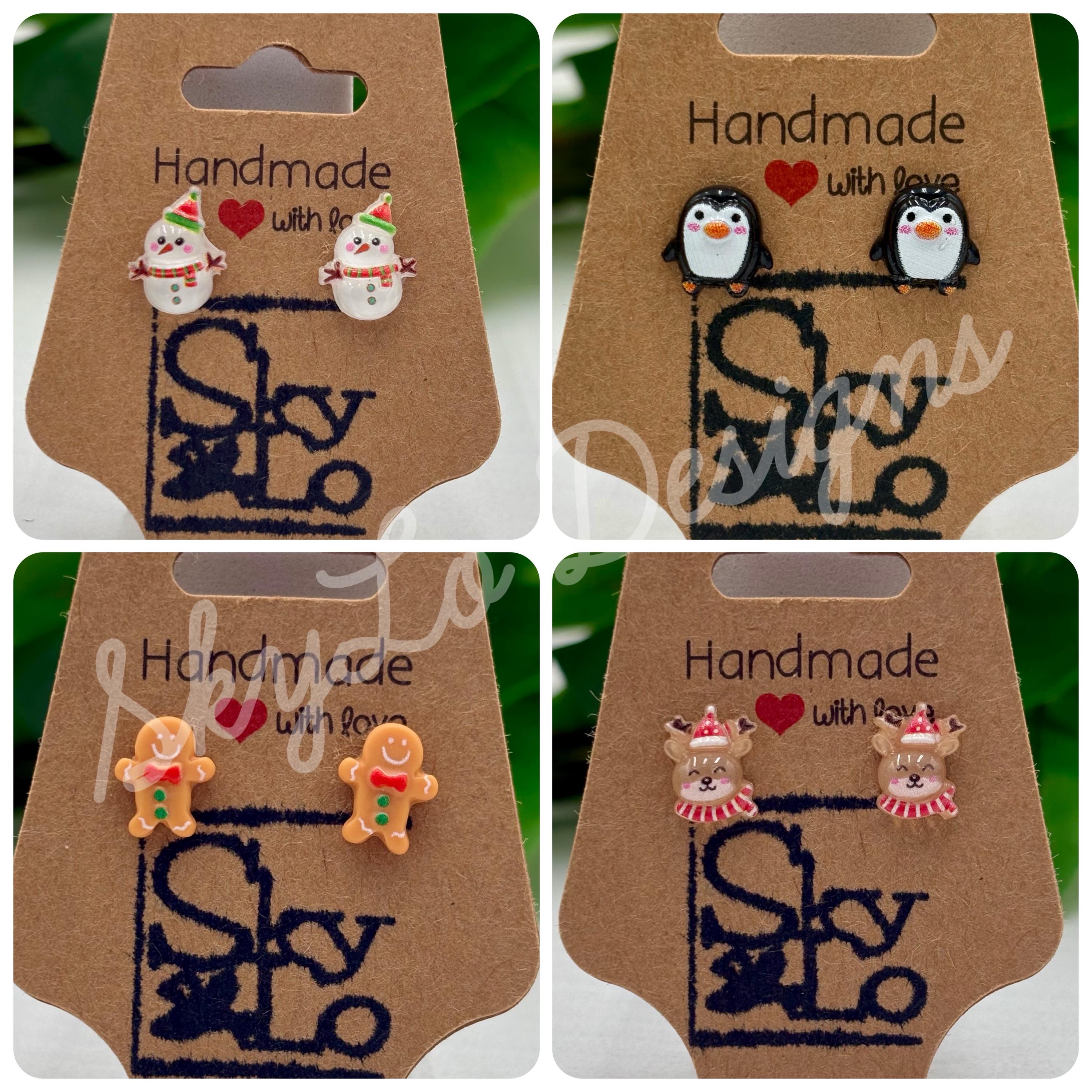 Set of four pairs of christmas themed earrings on display with 'SkyLo' branding.