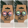 Pair of Mario bro’s mushroom-shaped earrings on a 'Handmade with Love' card.