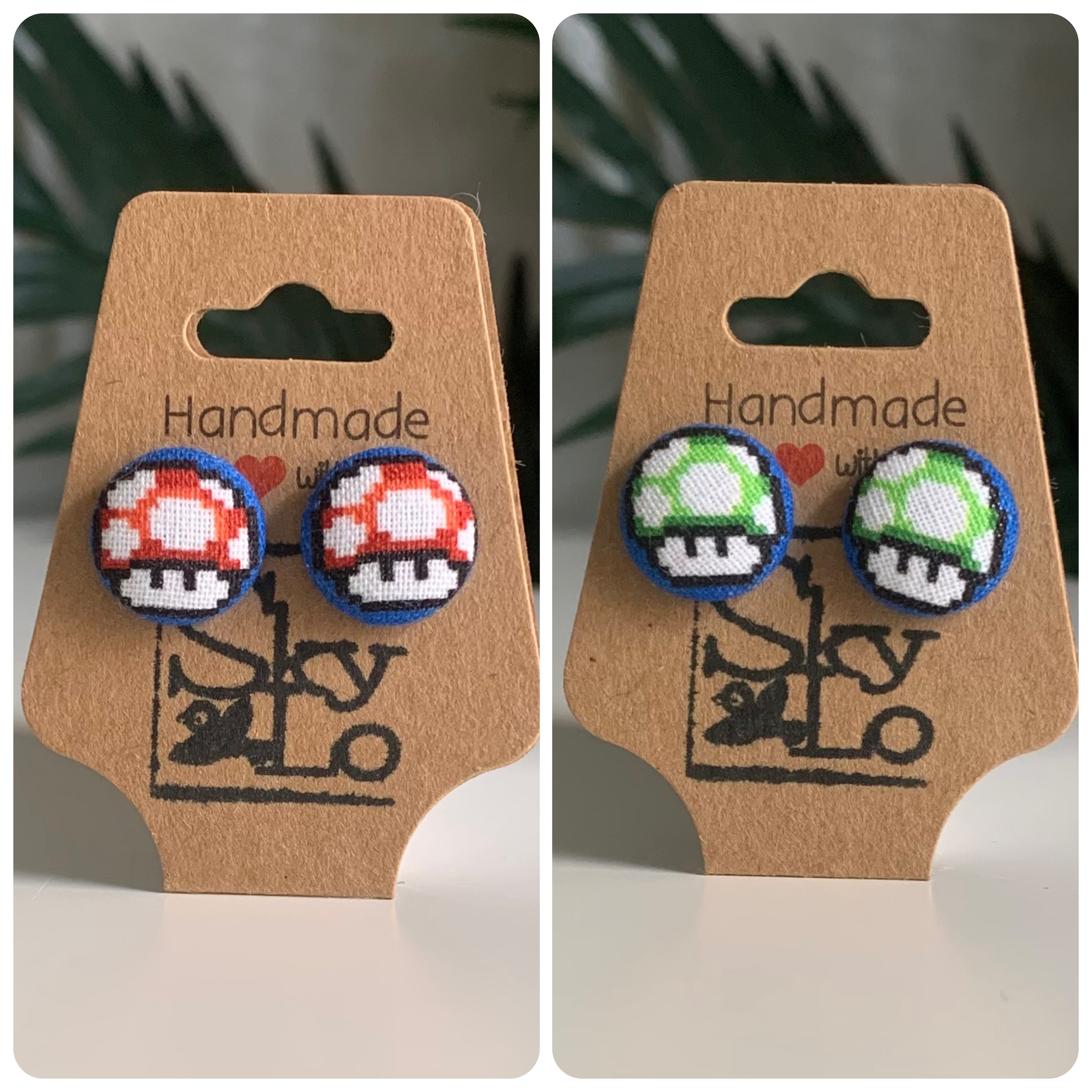 Pair of Mario bro’s mushroom-shaped earrings on a 'Handmade with Love' card.