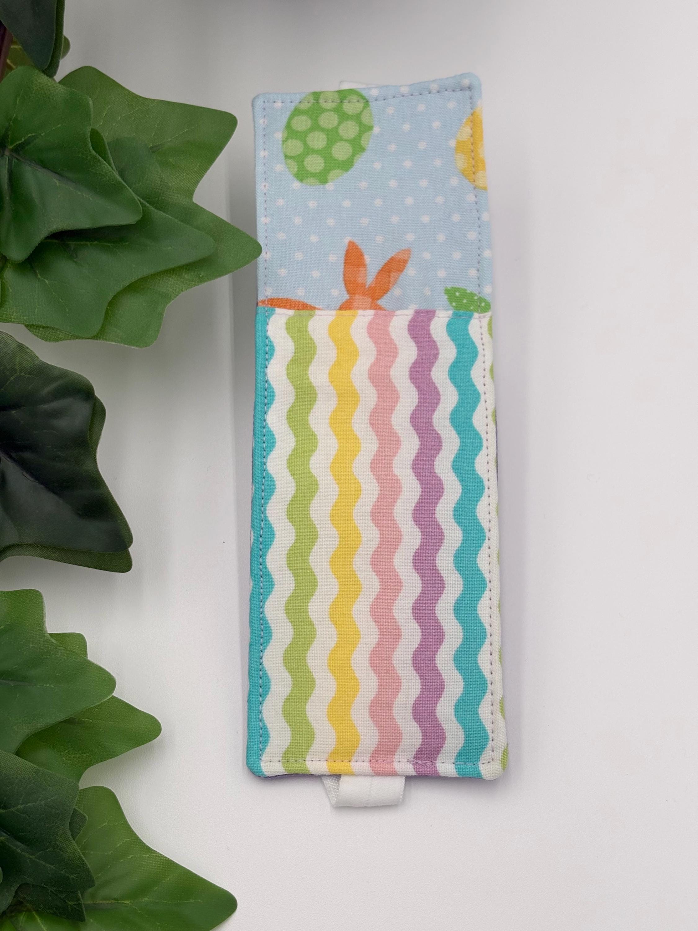 pastel multicolored Easter patterned pen holder on a white surface 