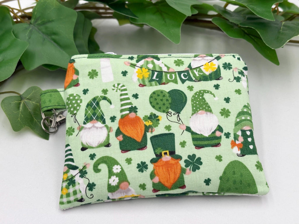 Small coin purse keychain with green st. patrick's day gnomes pattern on a white background with green leaves
