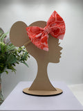 Pink Nylon Headband with a decorative hearts themed big bow on a mannequin head silhouette against a white background