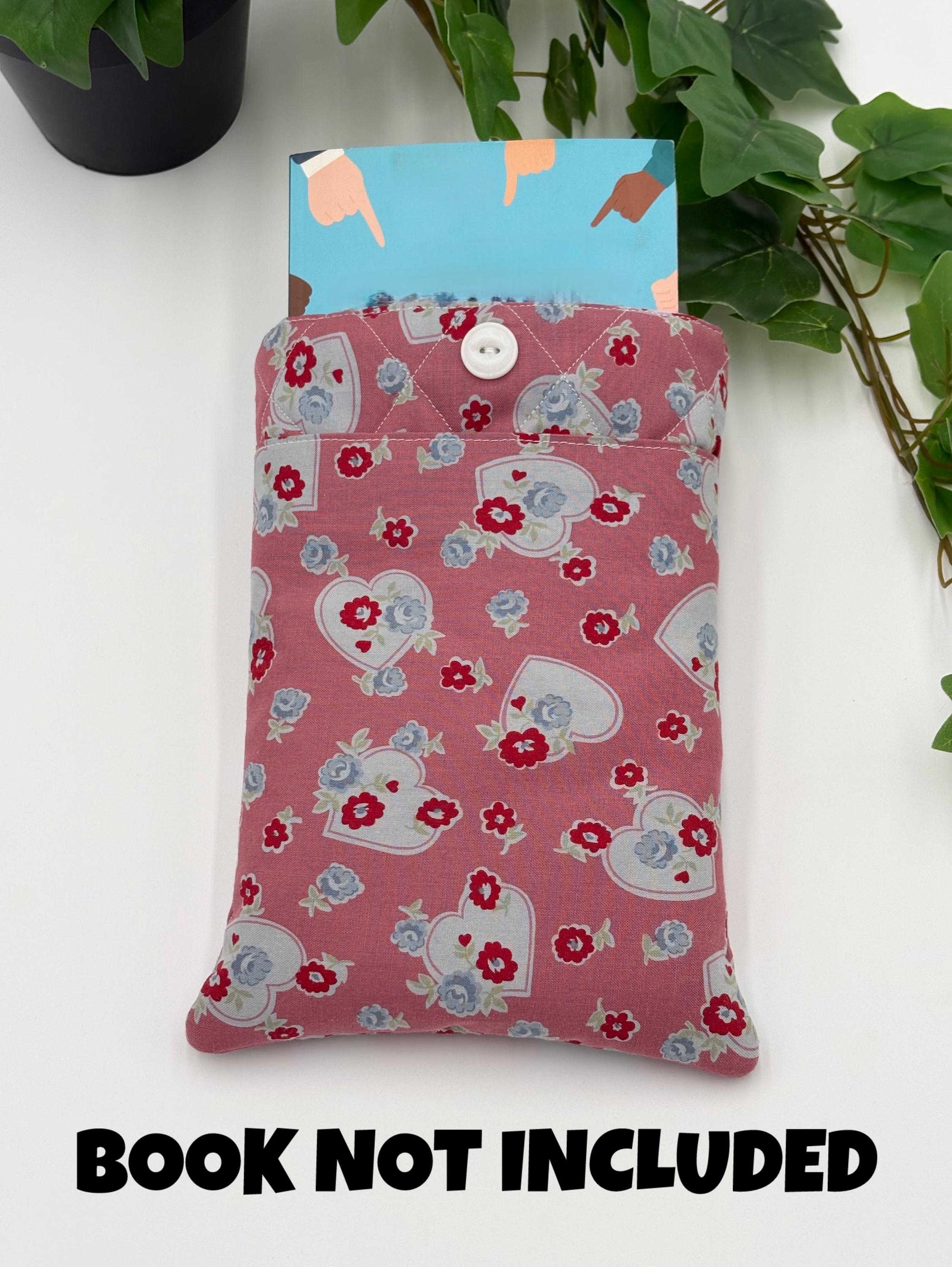 Floral and heart patterned book sleeve with book on a white background with text “book not included”