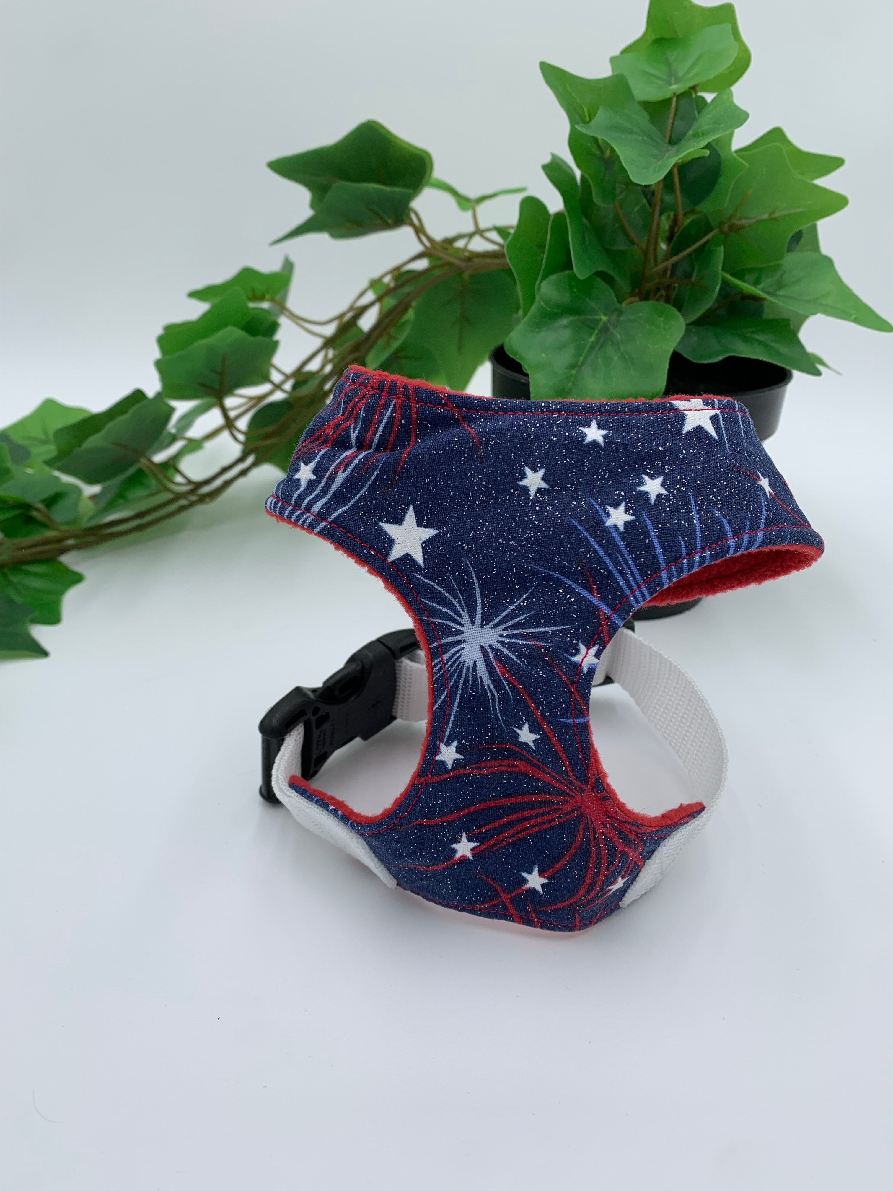 A blue 4th of July harness on a white background with a potted green plant