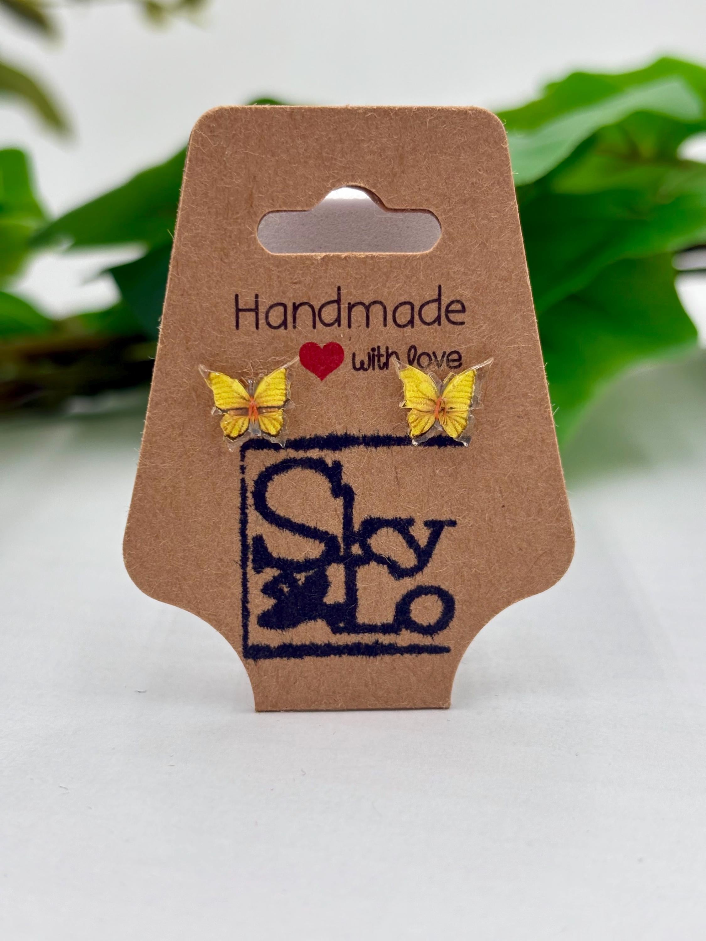 Yellow Butterfly earrings on a 'Handmade with Love' branded card with a green leafy background.