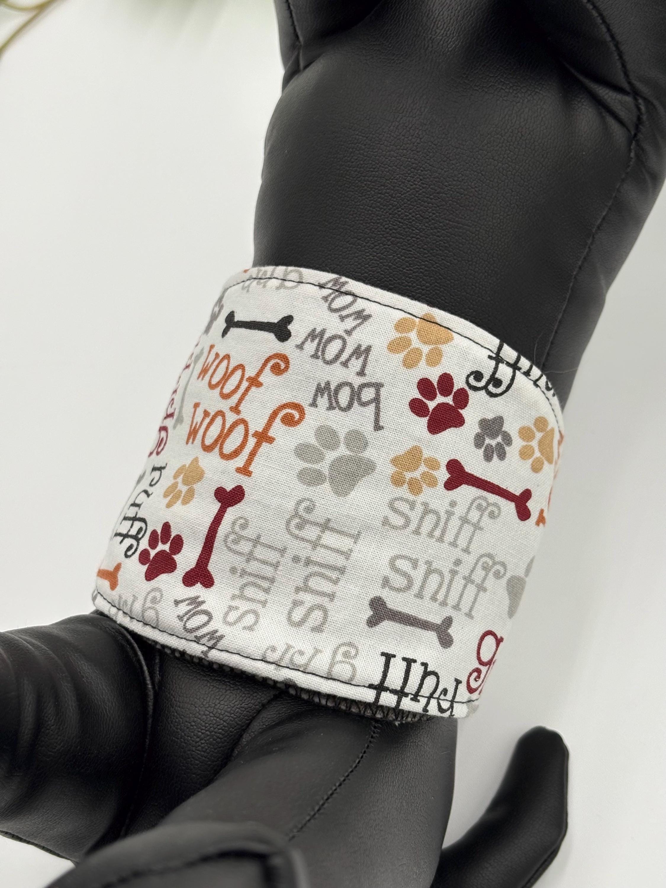 Under view of dog belly band with wood and grr material with the incontinence pad in it on a black dog mannequin with a plant and white background 