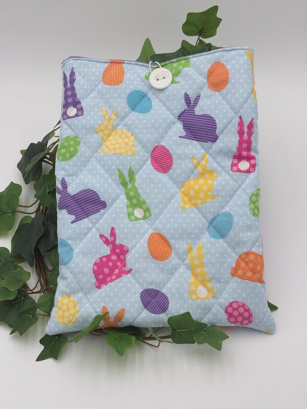 Quilted fabric Ipad Sleeve with Easter-themed designs on a white background