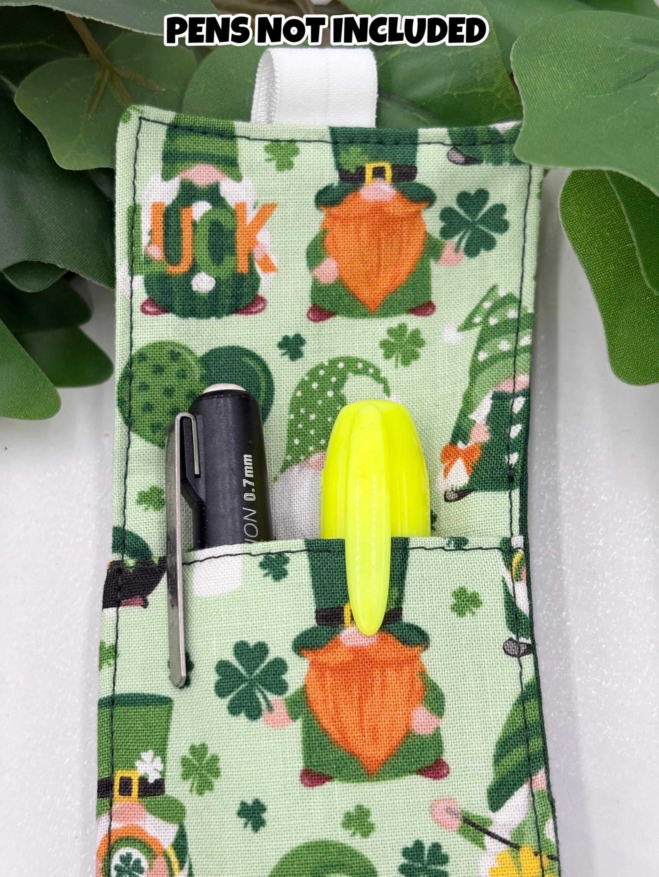 Pouch with St. Patrick's Day design featuring a black pen and yellow highlighter, surrounded by green leaves.