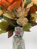 Bouquet of autumn leaves with a 'Surgical Tech' badge holder in front
