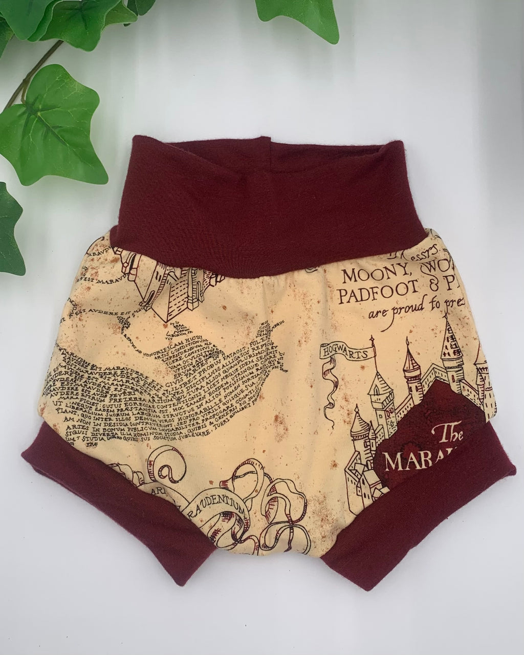 beige patterned bloomer with maroon waistband on a white background with greenery