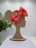 Red and Pink Headband with a decorative hearts themed big bow on a mannequin head silhouette against a white background