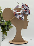 Autumn floral themed big bow nylon headband on a mannequin head with a white background and greenery 