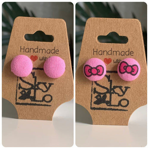 Pair of pink earrings with a pair of pink earrings with bow design on brown 'Handmade with Love' card.