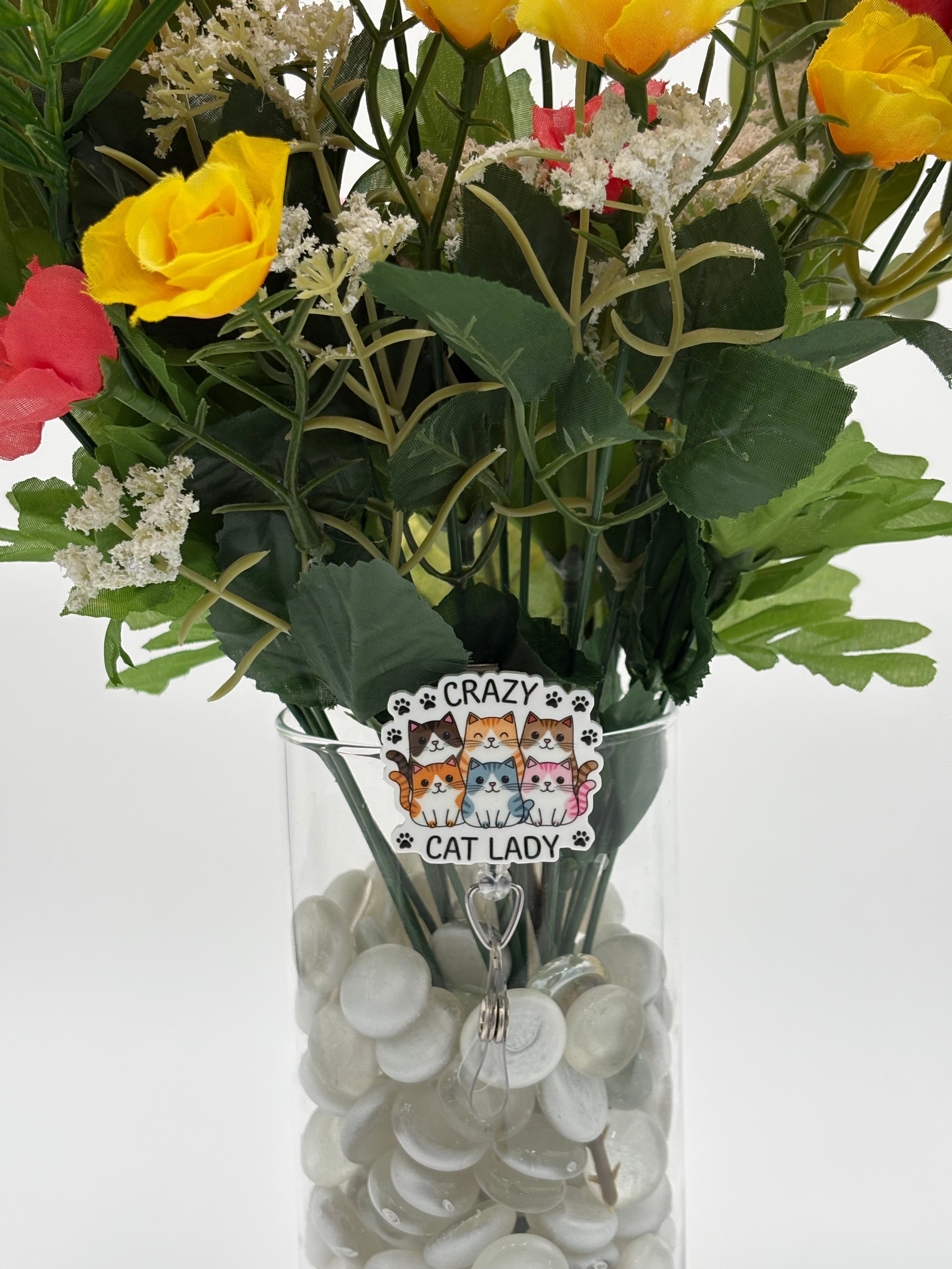 Bouquet of flowers with 6 cats with text "Crazy Cat Lady" badge holder in a clear vase on a white background