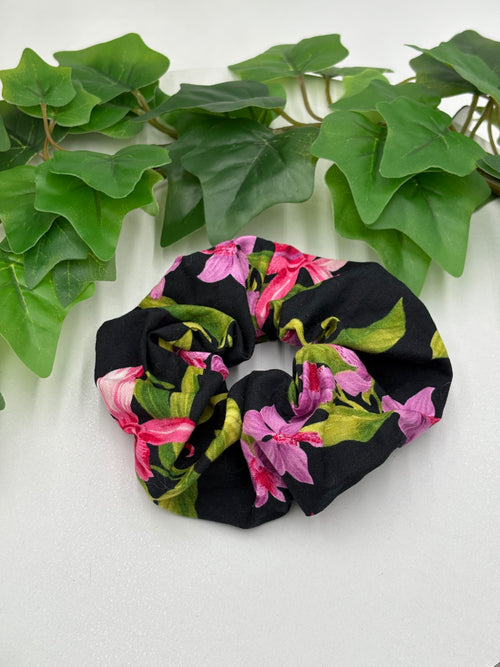 Floral scrunchie on a white background with green leaves