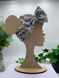 Colorful rainbow popsicles big bow headband on a mannequin head with a white background and greenery 