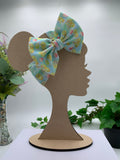 Rubber Duck themed big bow headband on a mannequin head with a white background and greenery 