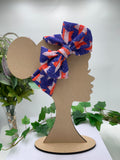 4th of July Star themed big bow headband on a mannequin head with a white background and greenery 