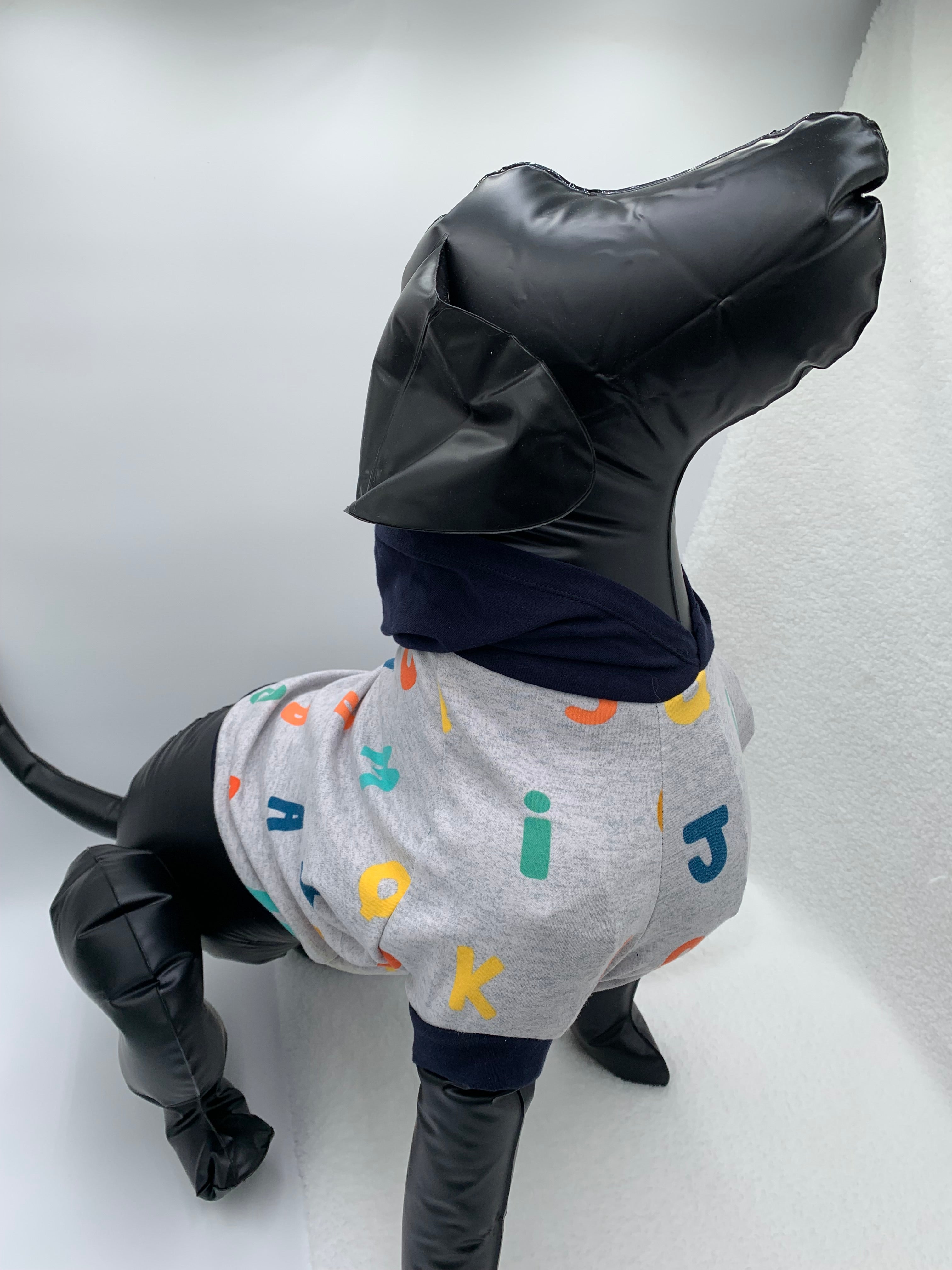 Black dog mannequin with Gray alphabet pattern hoodie on a white background 