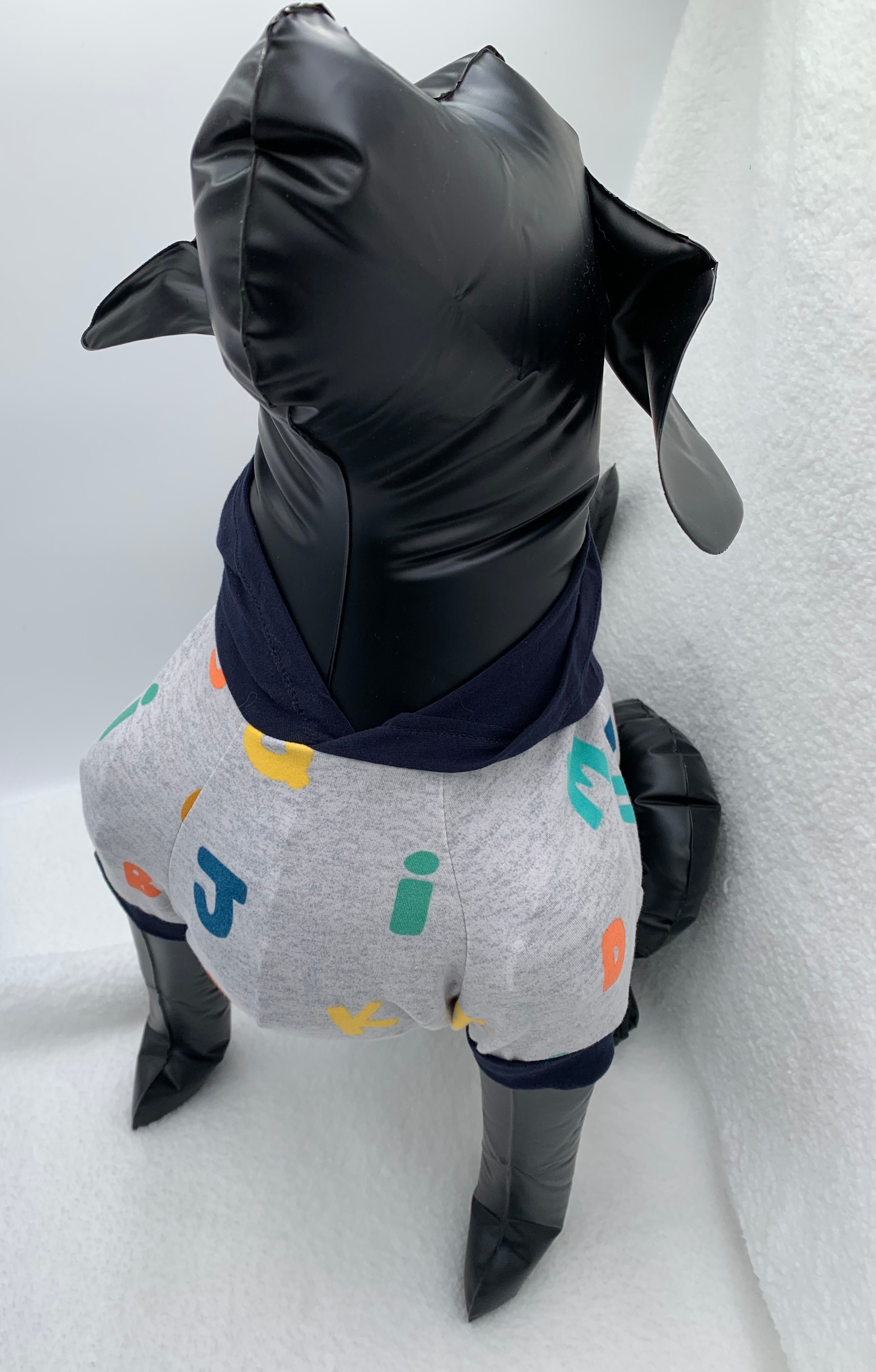 Black dog mannequin with Gray alphabet pattern hoodie on a white background 