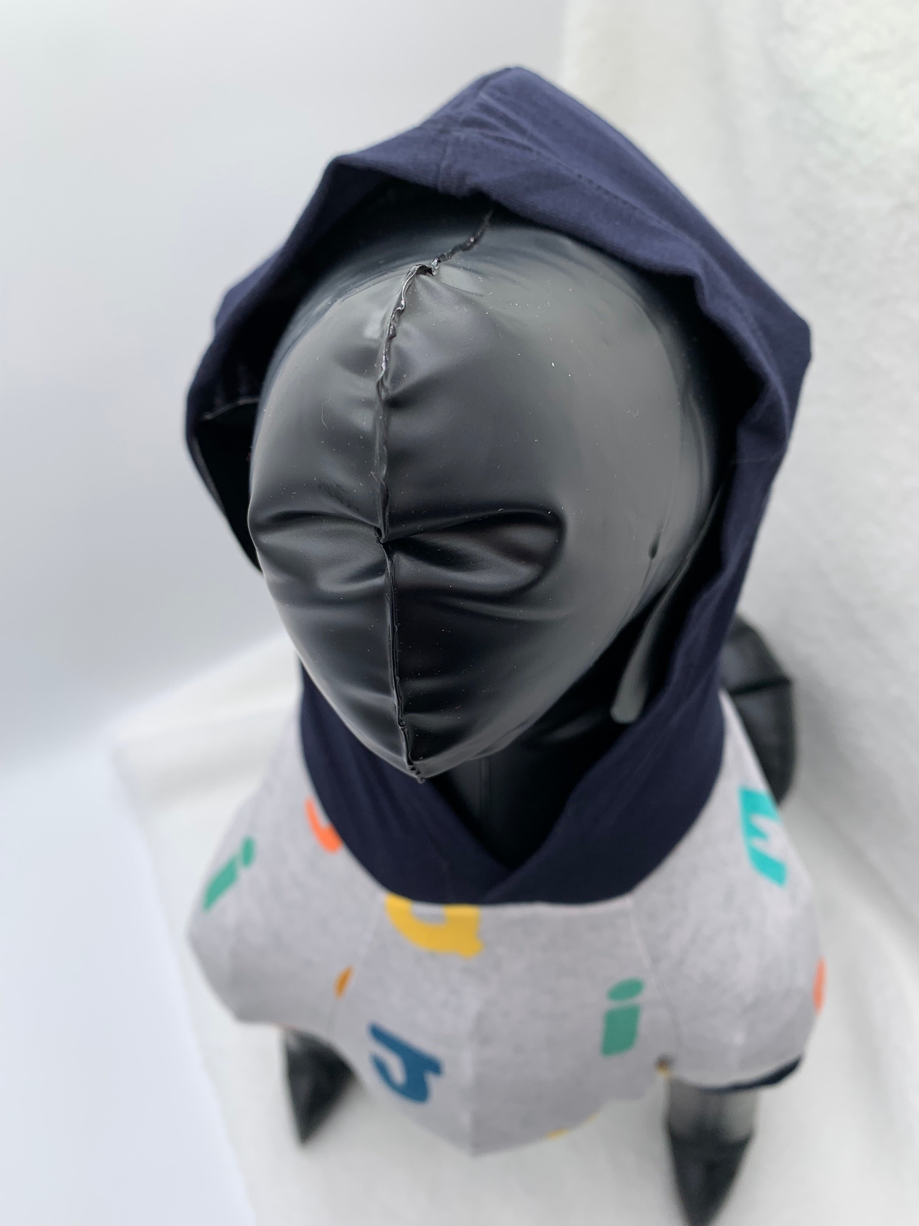 close up of Black dog mannequin with Gray alphabet pattern hoodie with navy blue hoodie up on a white background 