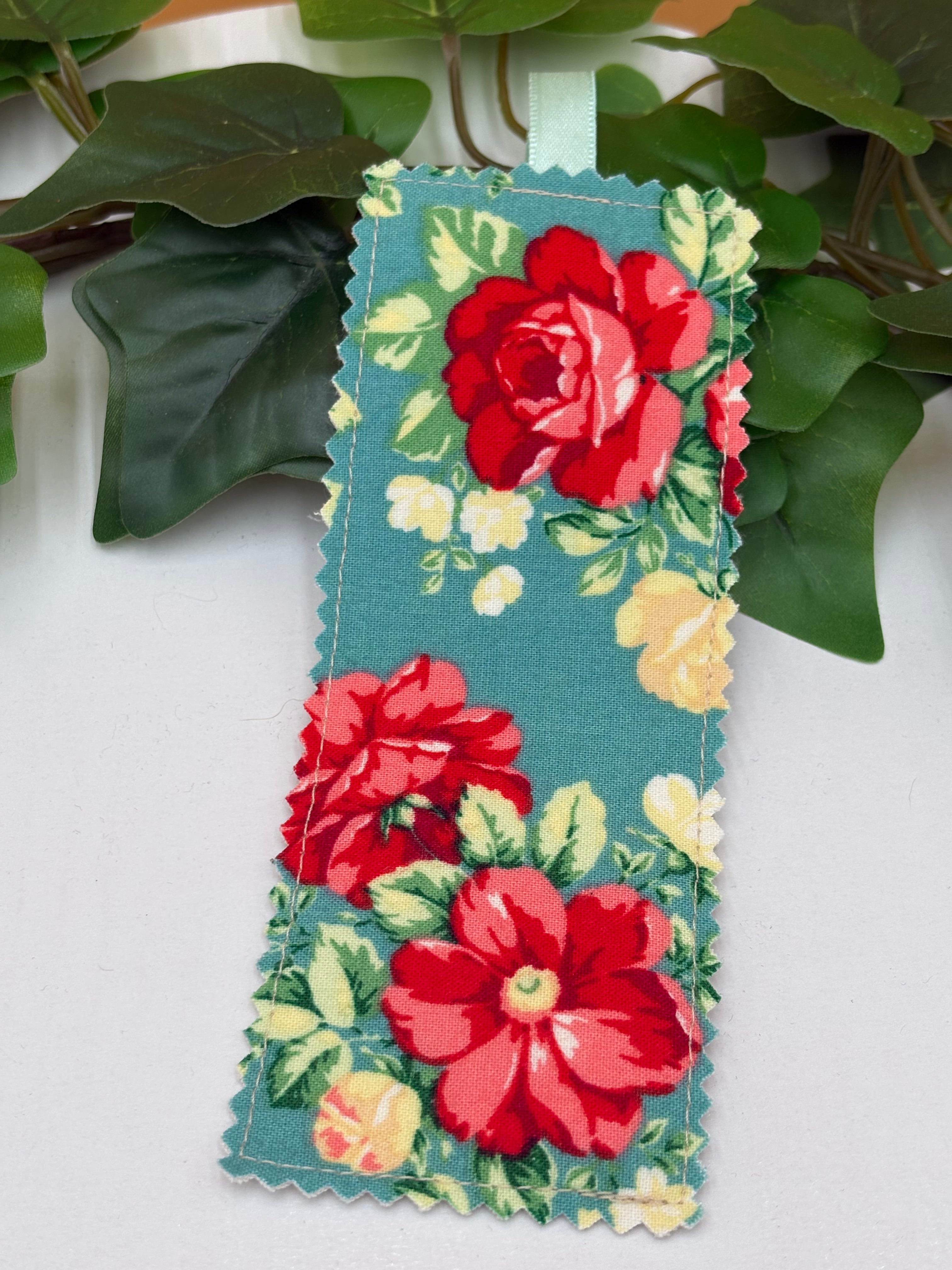 Teal Floral patterned fabric bookmark on a white background with green leaves