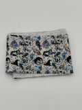 Folded fabric with wizard theme pattern on a white background