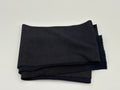 Folded fabric with navy blue with gold glitter on a white background