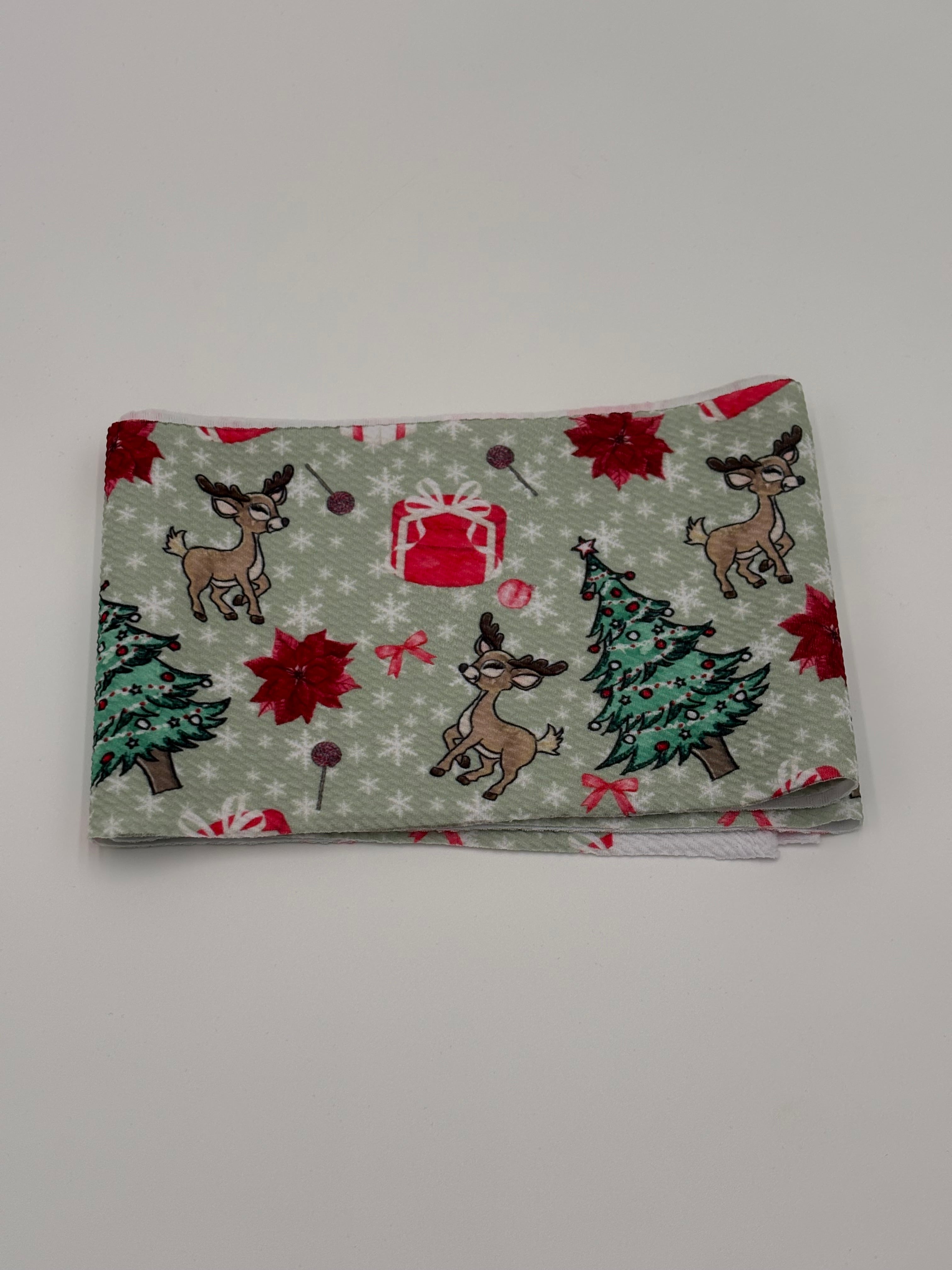 Folded fabric with Christmas-themed pattern on a white background