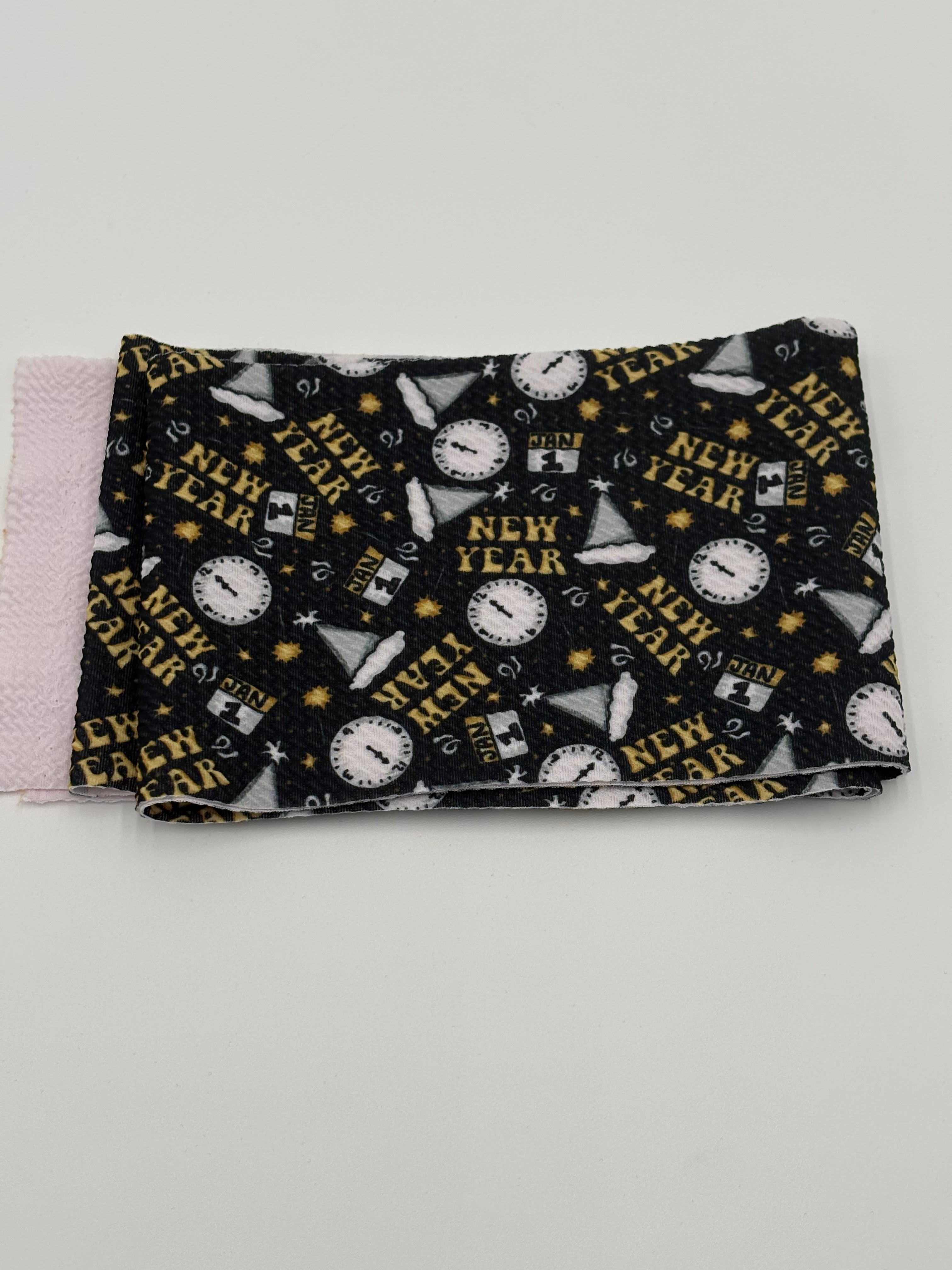 Folded fabric with New Year’s Eve pattern on a white background