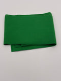 Folded lime green fabric on a white background