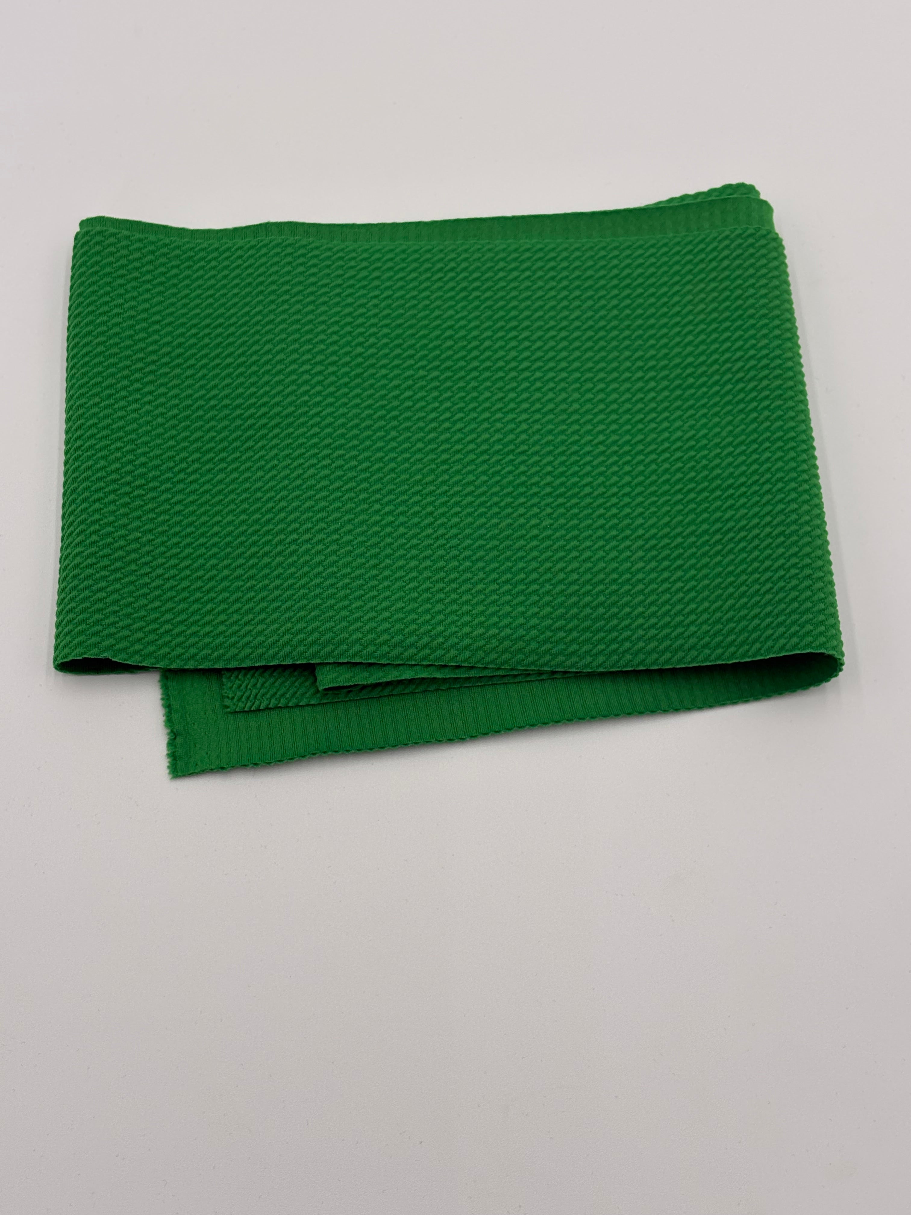 Folded lime green fabric on a white background