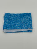 Folded fabric with blue bubbles pattern on a white background