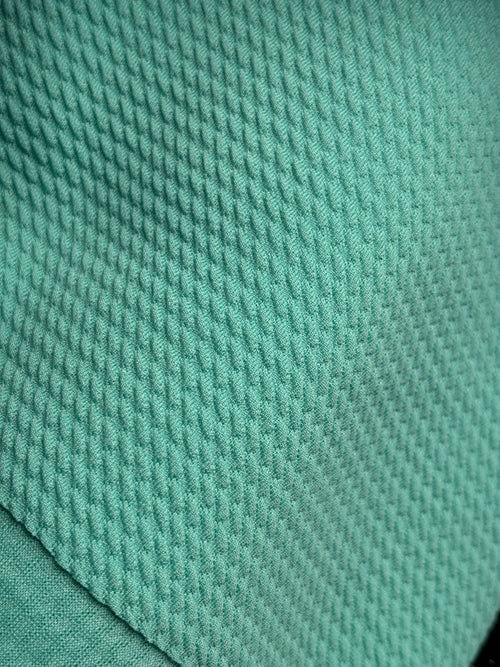 Close-up of aquamarine fabric with a textured pattern