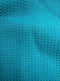 Close-up of aqua blue fabric with a textured pattern