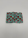Folded fabric with Valentine’s Day heart hot air balloons pattern on a white background