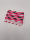 Pink fabric with green and white striped pattern on a white background