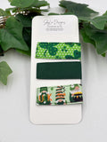 Set of green and white magnetic fabric bookmarks on a white card with leafy background