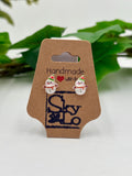 Pair of snowman-themed earrings on a 'Handmade with Love' card with a brand logo.