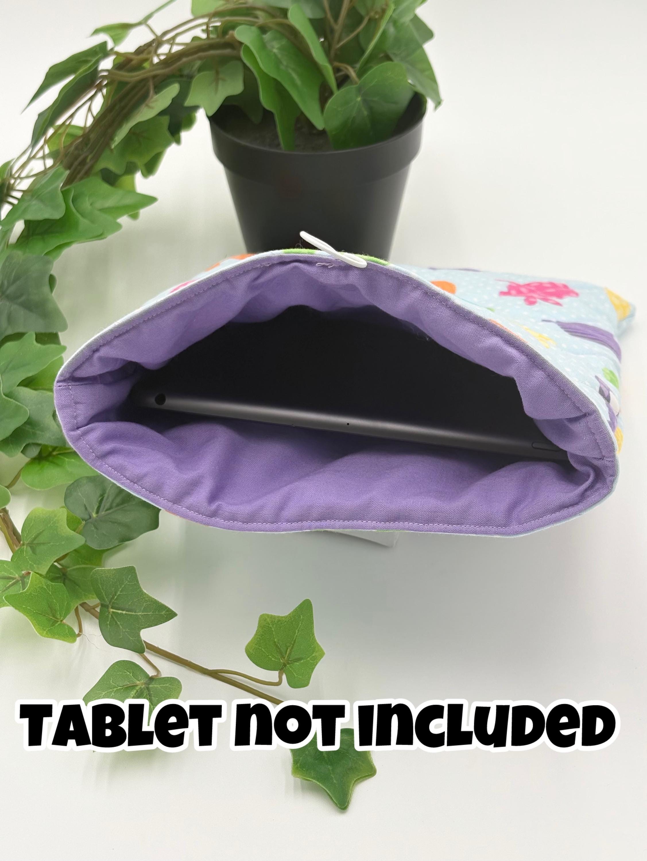 Easter patterned tablet case with purple interior on a white surface with green leaves with text "tablet not included".