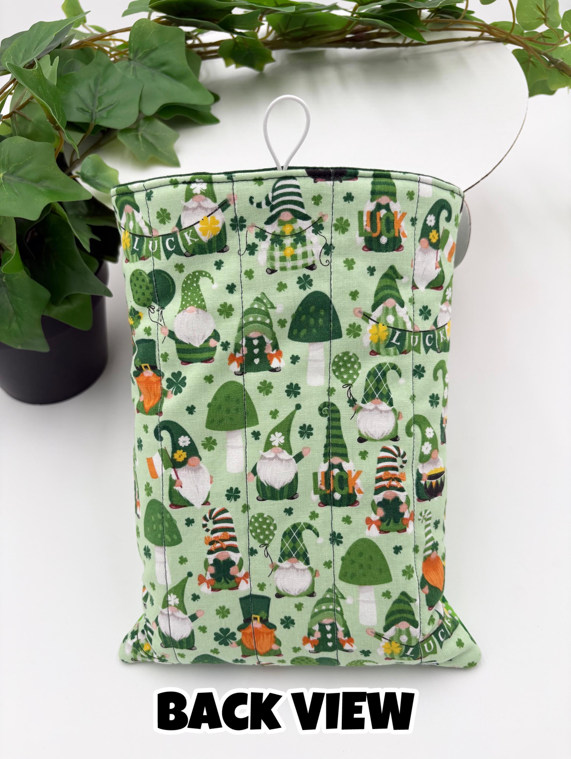 Green saint Patrick’s day gnomes patterned book sleeve with on a white surface and text “back view”