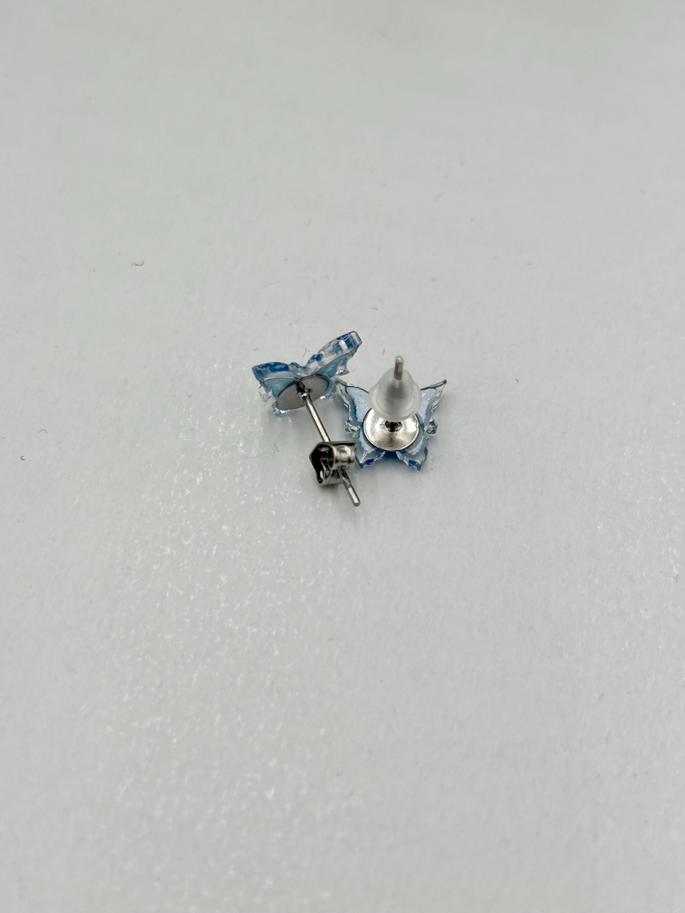 Pair of blue butterfly earrings on a White background