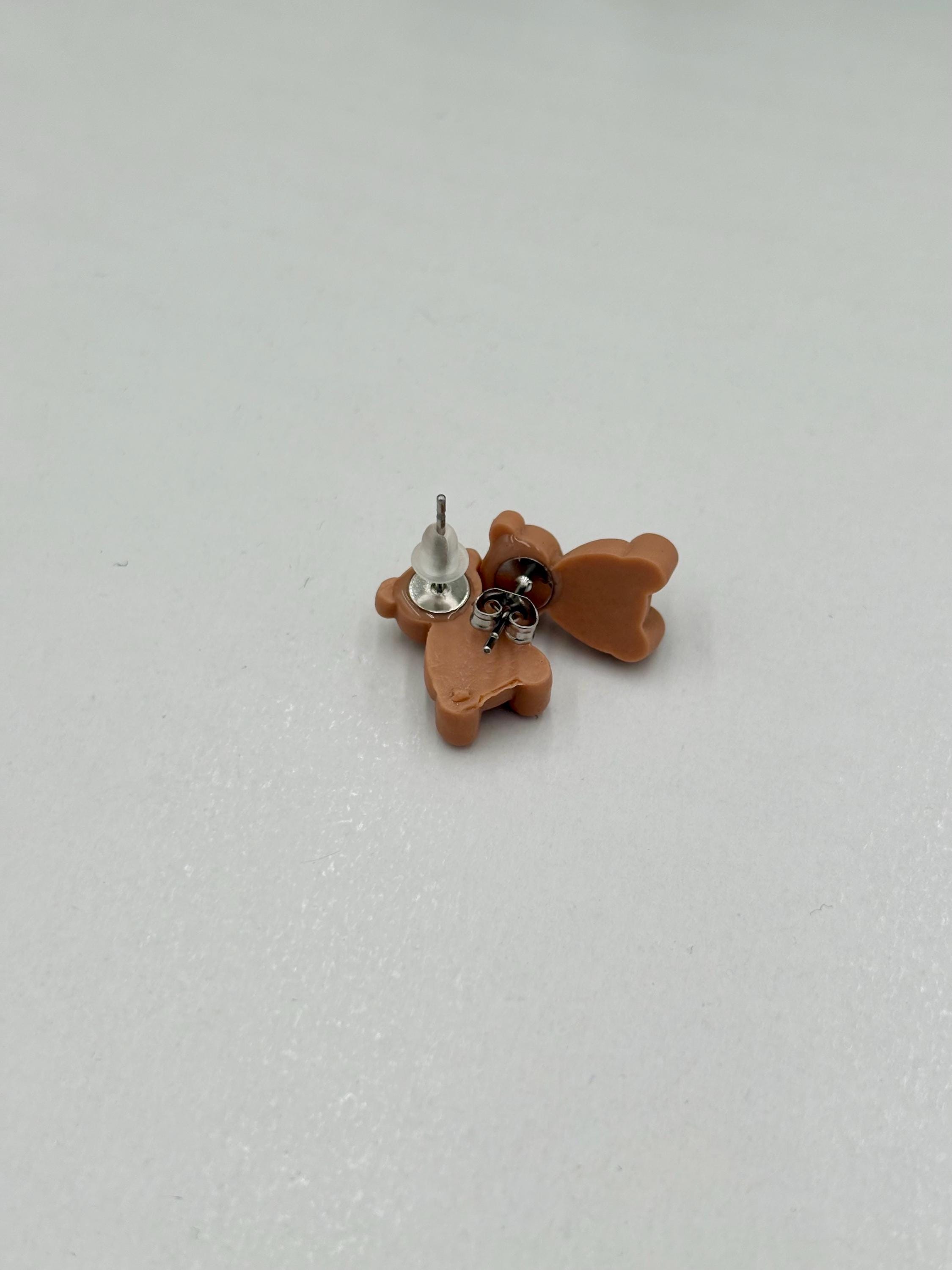 Brown teddy bear earrings on a white background