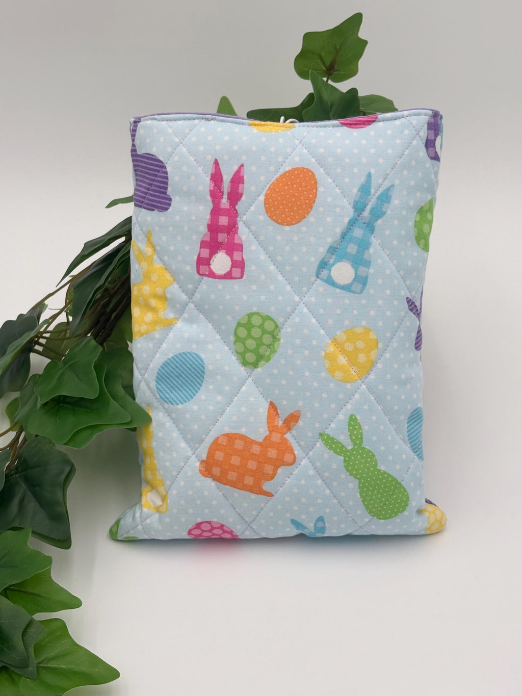 Quilted book and e-reader sleeve with Easter-themed design on a white background