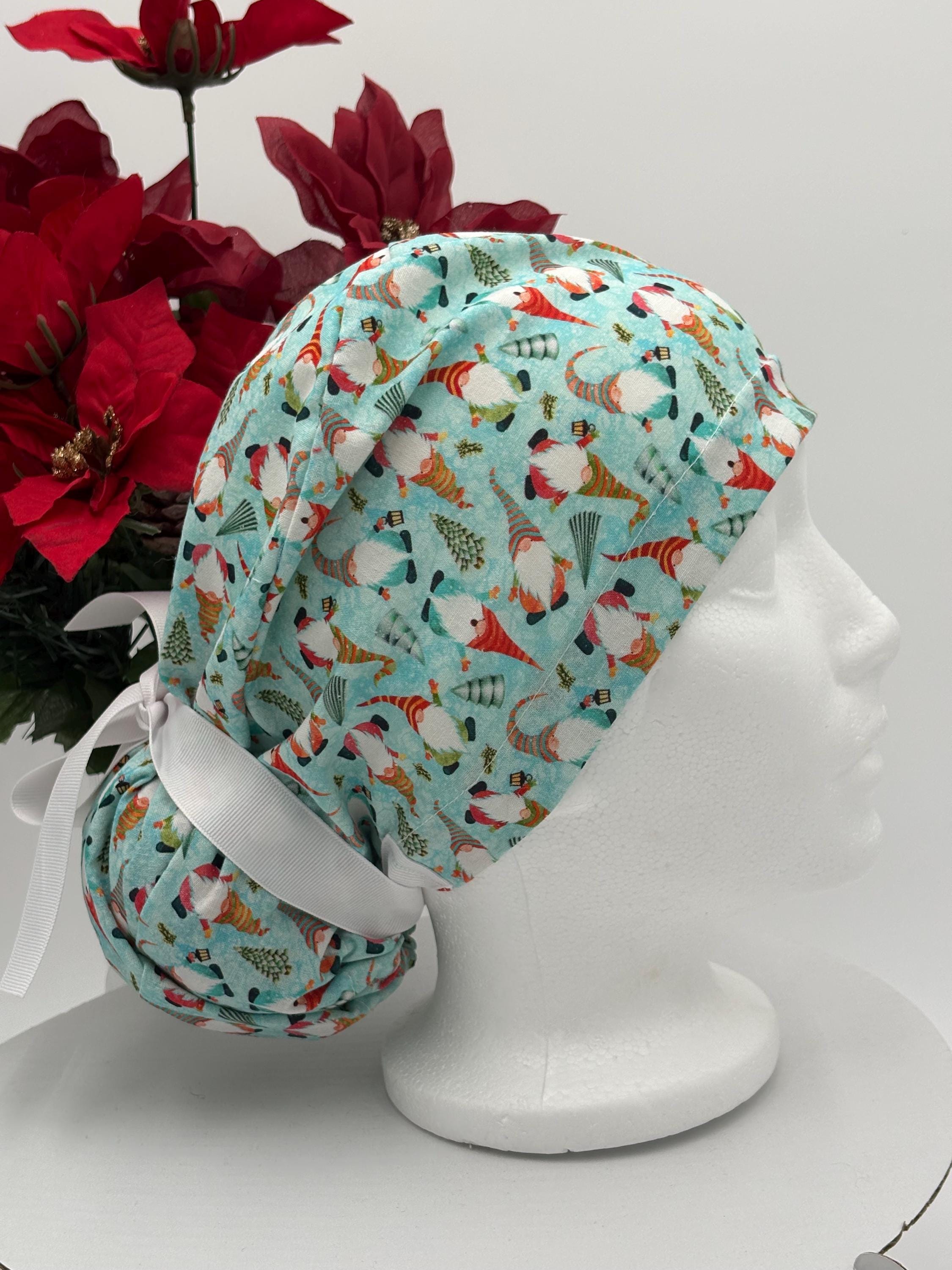 Gnomes scrub cap on a mannequin head against a white background with red flowers.