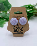 Pair of lavender round earrings on a 'Handmade with SkyLo' branded card with green leaves in the background.